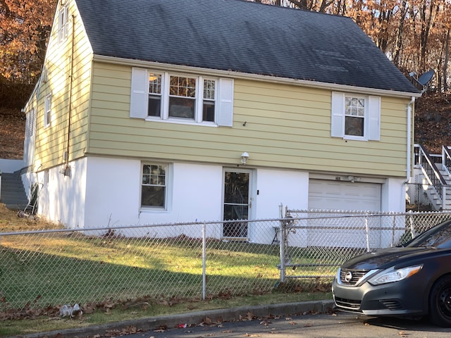 view of front facade with a front yard and a garage