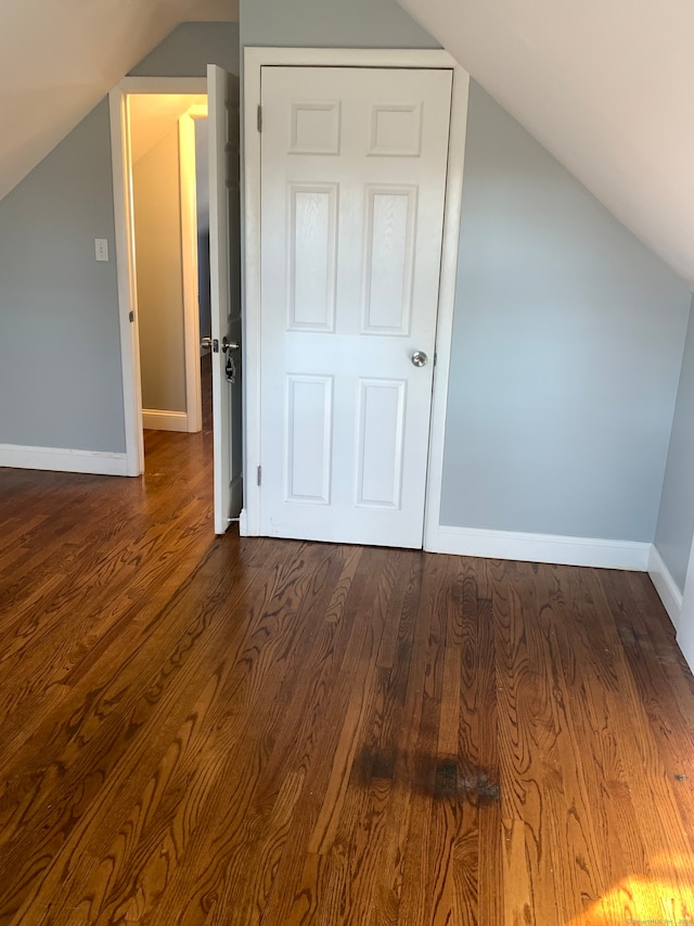 additional living space with wood-type flooring and lofted ceiling