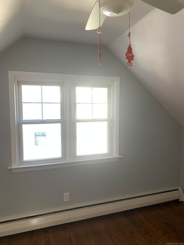 additional living space with lofted ceiling, dark wood-type flooring, and a baseboard radiator