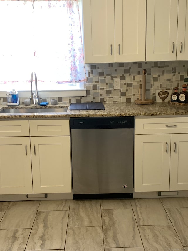 kitchen with white cabinetry, sink, and stainless steel dishwasher