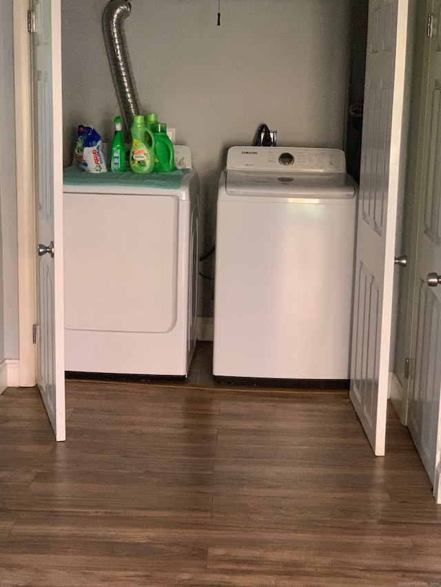 washroom with washer and clothes dryer and dark wood-type flooring