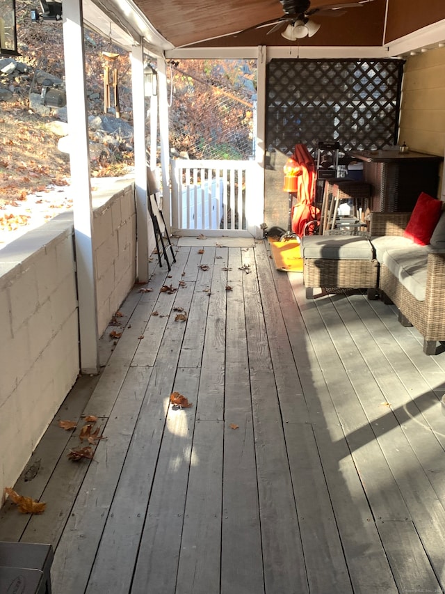 wooden terrace featuring ceiling fan and a porch