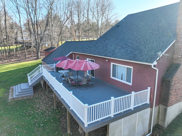 back of property with a yard and a wooden deck