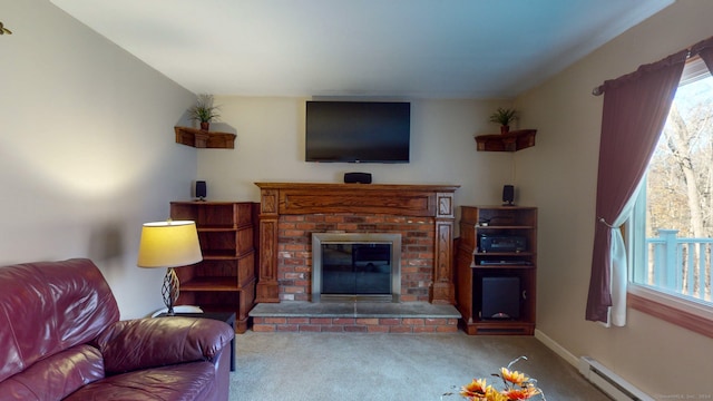 carpeted living room with a fireplace, a baseboard heating unit, and a healthy amount of sunlight