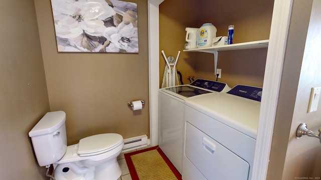 laundry area featuring tile patterned flooring, baseboard heating, and washing machine and clothes dryer