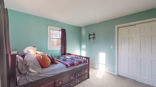 bedroom with light colored carpet and a closet