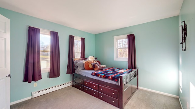 carpeted bedroom featuring baseboard heating