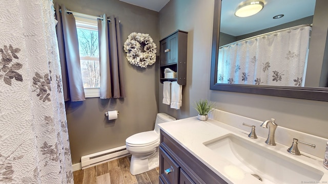 bathroom featuring toilet, vanity, a baseboard radiator, and wood-type flooring