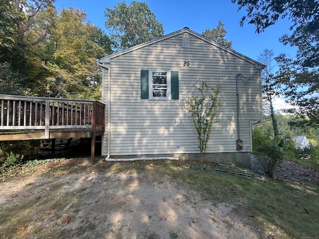 view of side of home featuring a wooden deck