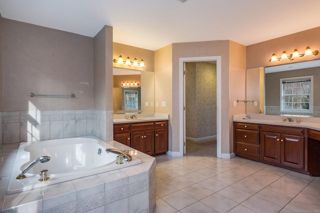 bathroom with vanity, tile patterned floors, and tiled tub