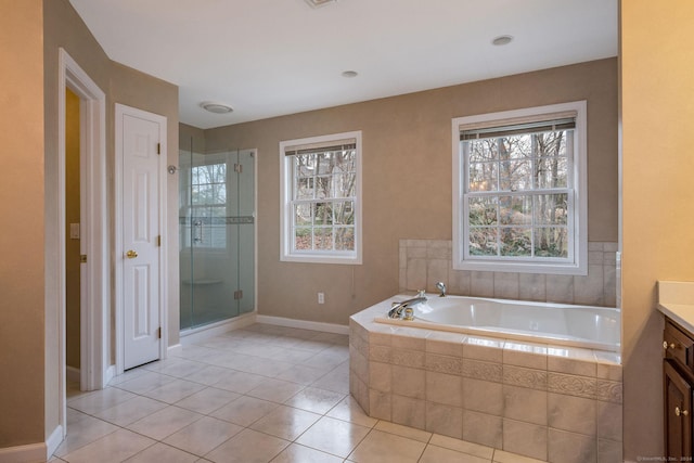 bathroom featuring plus walk in shower, vanity, and tile patterned floors