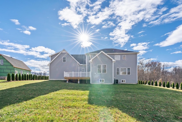 back of property featuring central air condition unit, a yard, and a deck