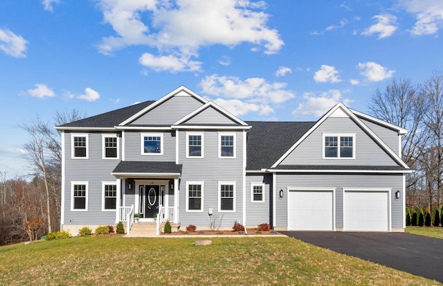 view of front of home featuring a front yard and a garage