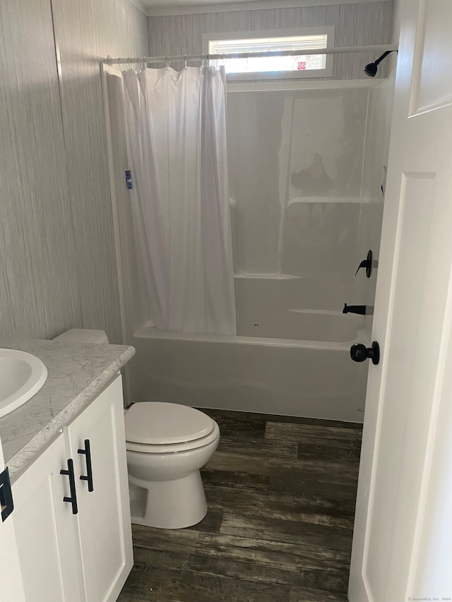 full bathroom featuring vanity, hardwood / wood-style floors, toilet, and shower / tub combo