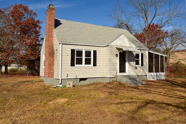 view of front of property with a front lawn and a sunroom