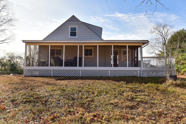 rear view of property with a sunroom