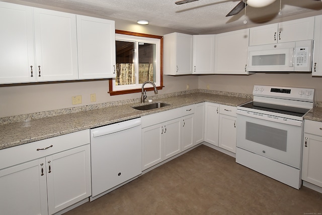 kitchen featuring a textured ceiling, white cabinetry, white appliances, and sink