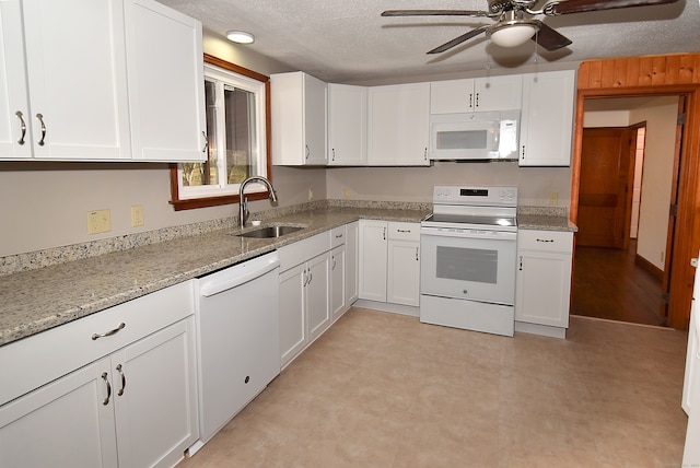 kitchen featuring white cabinets, a textured ceiling, white appliances, and sink