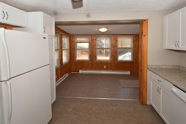 kitchen featuring light stone counters, white cabinets, a baseboard radiator, and white appliances