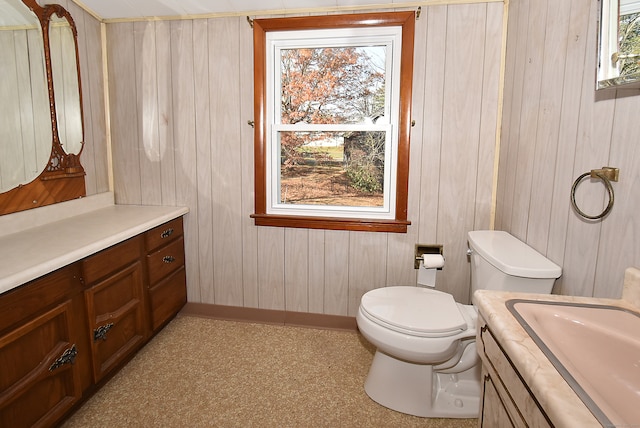 bathroom with vanity and wooden walls