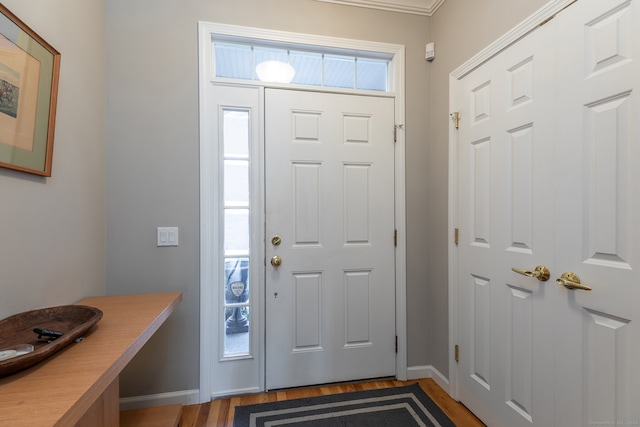 foyer with hardwood / wood-style flooring and ornamental molding