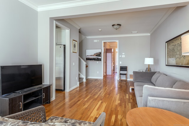 living room with light hardwood / wood-style flooring and ornamental molding