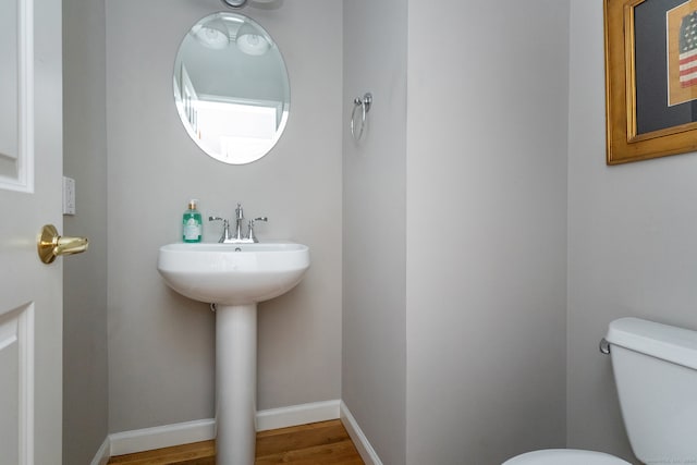 bathroom with sink, wood-type flooring, and toilet