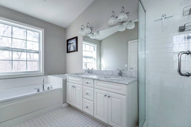 bathroom with vanity, plus walk in shower, and vaulted ceiling