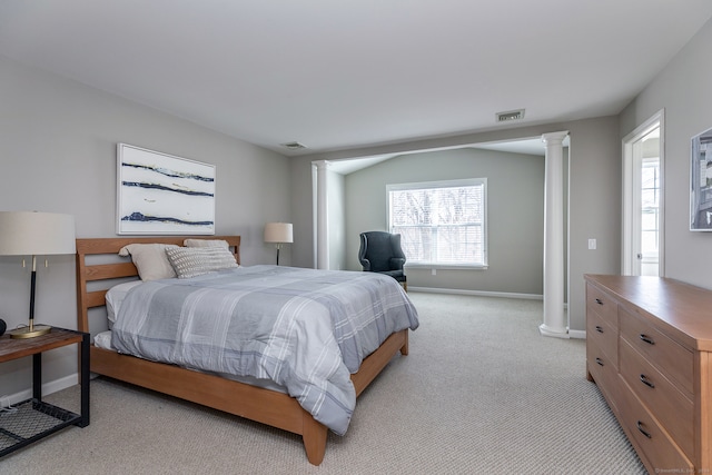 bedroom featuring ornate columns and light carpet