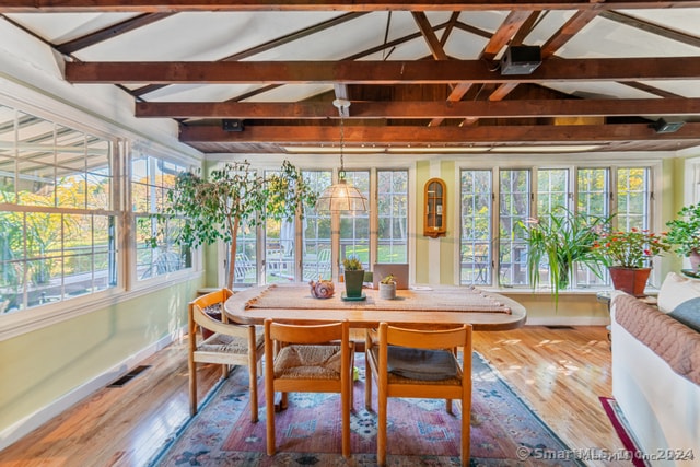 sunroom with lofted ceiling with beams