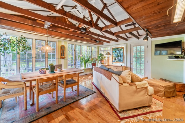 sunroom / solarium with lofted ceiling with beams