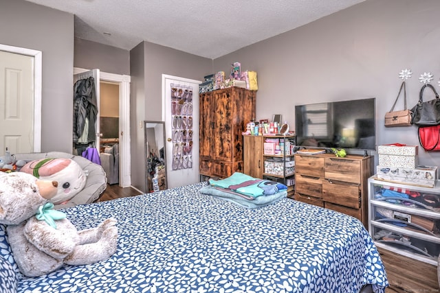 bedroom with a textured ceiling and hardwood / wood-style flooring