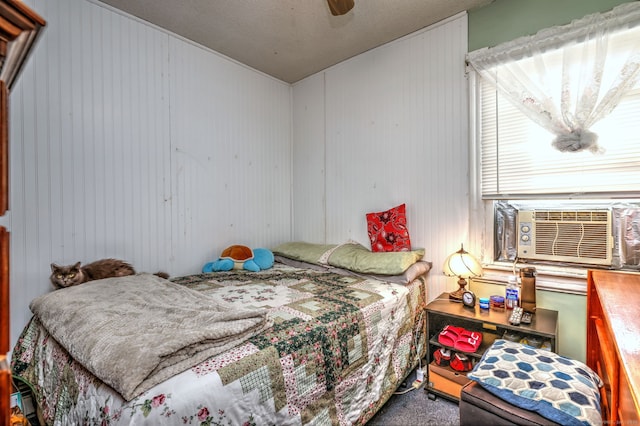 bedroom featuring carpet flooring, ceiling fan, and cooling unit