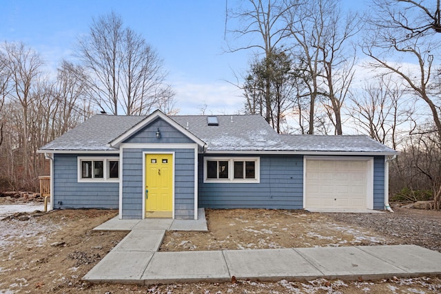 view of front of house with a shingled roof and a garage