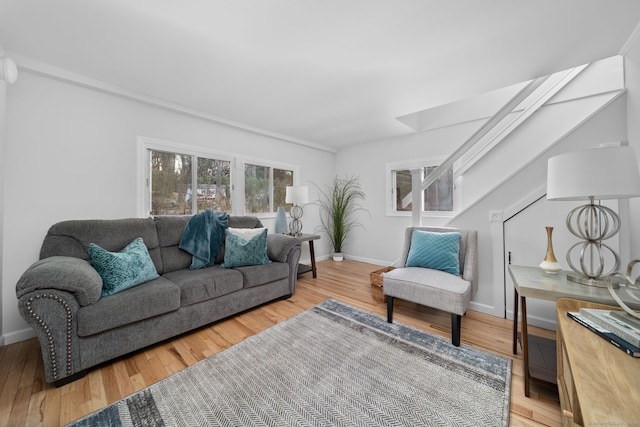 living room with baseboards and light wood finished floors