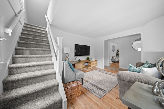 living room featuring stairs and wood finished floors