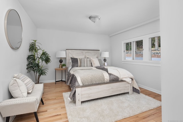 bedroom with baseboards and wood finished floors