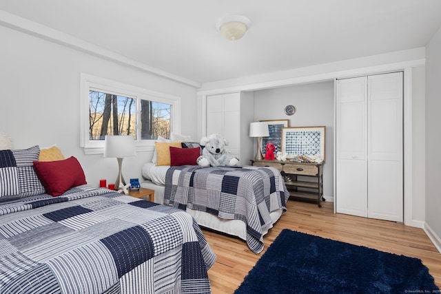 bedroom with baseboards and light wood-type flooring