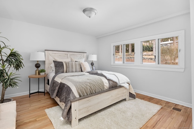 bedroom featuring wood finished floors and baseboards