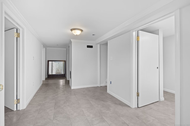 hall featuring crown molding and baseboards