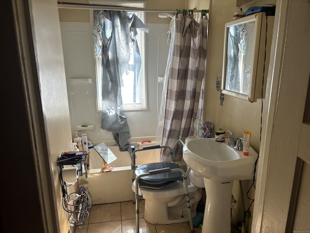 bathroom with tile patterned floors, toilet, and shower / bathtub combination with curtain