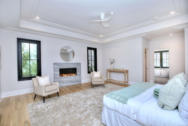 bedroom with crown molding, ceiling fan, light hardwood / wood-style floors, and multiple windows