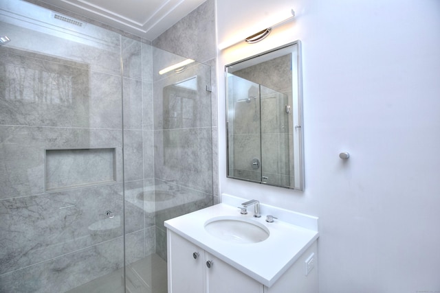 bathroom with vanity and a shower with door