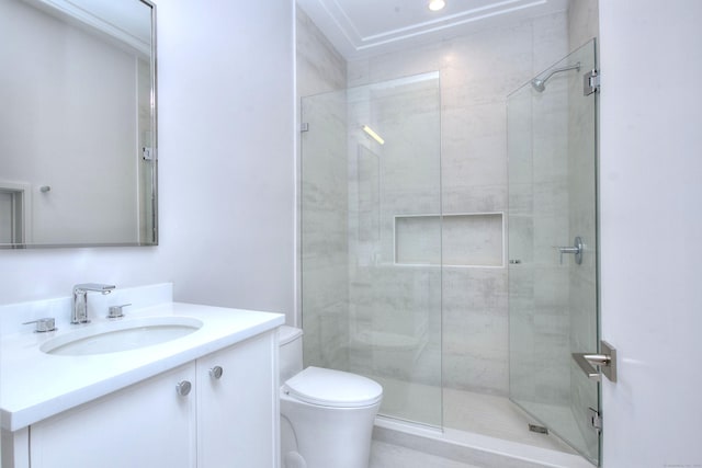 bathroom with vanity, toilet, and a shower with shower door