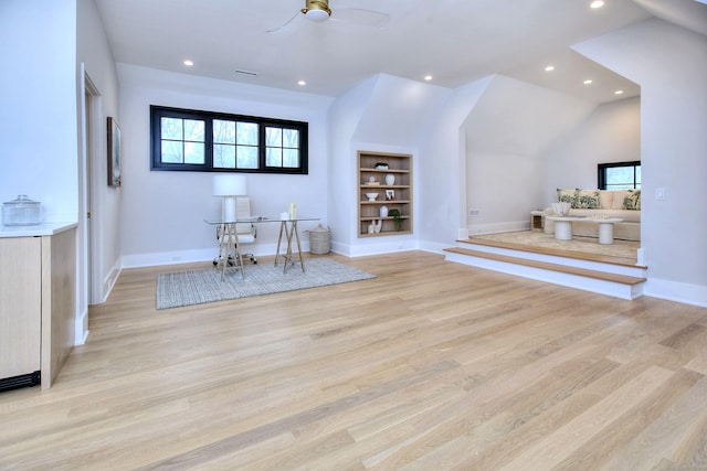 interior space featuring lofted ceiling, light hardwood / wood-style flooring, ceiling fan, and built in shelves