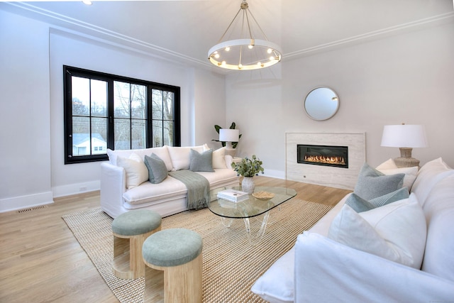 living room featuring an inviting chandelier and light hardwood / wood-style flooring