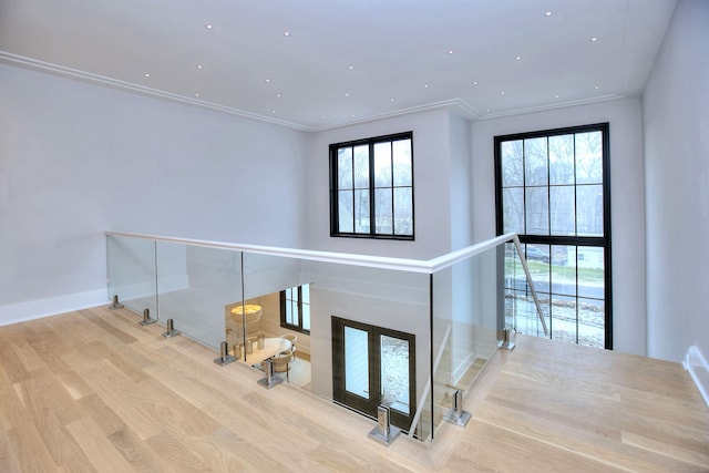 interior space with ornamental molding and light hardwood / wood-style floors