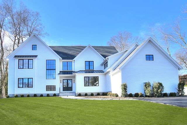 modern farmhouse style home featuring a front lawn