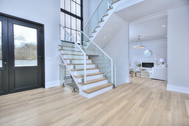 entrance foyer with light hardwood / wood-style flooring and ornamental molding