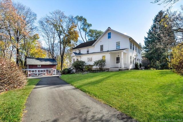 view of front of property with a front lawn and an outdoor structure